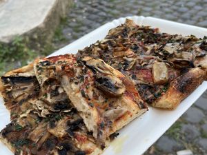 Vegan pizza with mushrooms and some herbs  at La Prezzemolina in Rome