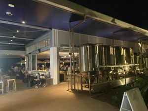 Restaurant w/ brewing equipment on the right and the river in the background   at Auckland House in Gladstone