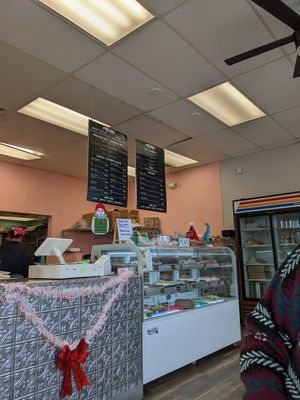 Case and cash register, signs clearly marking what's vegan at Haven On Earth Bakery & Deli in Reno