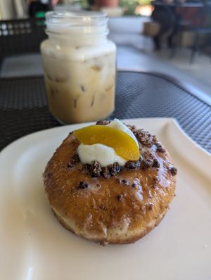 Cold latte & peach donut at Sabor A Vida Cafe & Deli in Vista