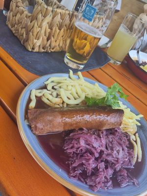 Rolled salty pancake filled with carrots and pickled cucumbers  sweet sour cooked red cabbage, Spaetzle and dark gravy at Landgasthof Löwen in Aitrach
