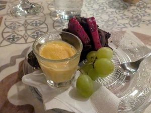 Amazing dessert of chocolate cake, fruit, and a Dubai truffle hiding behind the citrus gelato at O Linós in Paphos