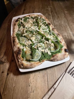 Vegan pizza with pesto, asparagus, green veg. Warning that the menu does not state that almonds come on top  at Di Marzano Cafe Vermuteria in Lisbon