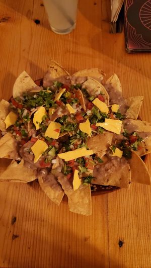 These are the Aztlan nachos with vegan cheese option.  The cheese isn't great. at Calavera Coyote Pulquería in Puebla
