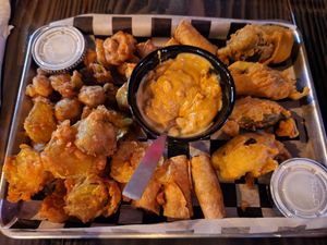 Vegan fried platter with vegan ranch & cashew queso. Fried mushrooms, pickles, Impossible beef taquitos, jalapeño poppers stuffed w/ Impossible beef and shredded v cheddar at Torque Grill & Cantina in Burleson