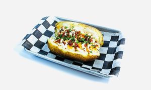 Loaded Baked Potato made with vegan butter, vegan sour cream. vegan shredded cheese. at Torque Grill & Cantina in Burleson