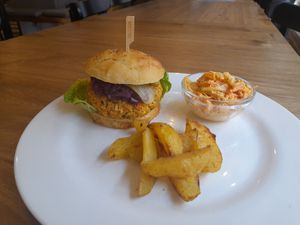Luštěninovo-zeleninový burger v domácí mrkvové bulce, coleslaw salát a pečené brambory at Družstvo Viktorina Loca in Pribor