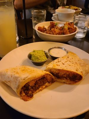 Breakfast burrito and a bowl of the sticky cauliflower and rice. at Botanical Plant-Based Fare in Charlottesville