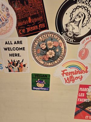 Stickers on toilet door at Enfants Terribles Café in Rennes
