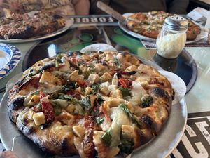Pizza with vegan cheese, chicken, spinach, and sun dried tomatoes    at Task Force Pizza Co in Fort Walton Beach