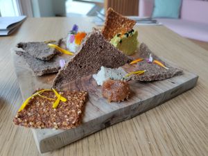 Cheese plate with 2 types of crackers (fennel and tomato), two different cheeses (one cashew, one sunflower) and a date paste. Yum! at Inward in Tunis