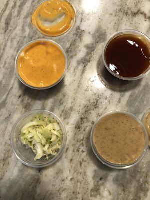 Twist sauce, Mumbo BBQ, vegan honey mustard, and slaw, all very tasty  at Twist Hot Chicken in Peoria
