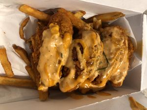 Twist hot tenders with fries … half the fries are gone 😬  at Twist Hot Chicken in Peoria