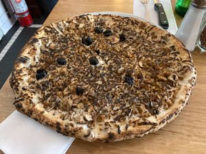 Vegan pizza with cremini mushrooms, olives, vegan sausage, and vegan cheese. at Motorino in New York City