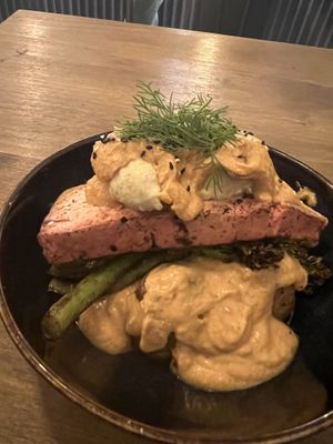 Salmon filet over potatoes with a dill sauce   at Meet Vegano in Malaga