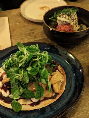 Braised tofu tortilla with fries and salmon tofu bowl at Meet Vegano in Malaga