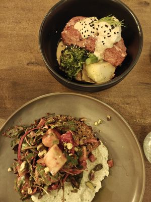 Salmon bowl and seitan salad at Meet Vegano in Malaga