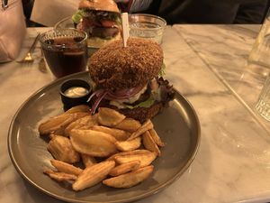 Burger with deep fried brioche bun and french fries   at Meet Vegano in Malaga
