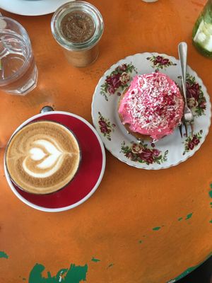Almond latte and a vegan Boston raspberry bun at Queen Sally's Diamond Deli in Wellington