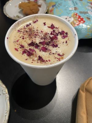Rosy Cardamom Latte w Oat (tahini choc chip cookie in the background)  at The Owl's Nest in Olympia