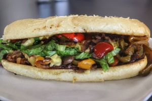 Our new Philly! Choice of Unreal Deli steak or soy curl chicken, bell peppers, onions, mushrooms, hot peppers, lettuce, Mayo, and Chao cheese on a La Baguette hoagie roll.  at Midtown Vegan Deli & Market in Tucson