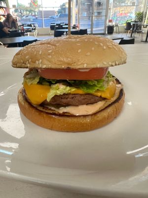 The Return of The Mac! Choose between a Beyond Patty or our house made black bean Patty, house made thousand island, lettuce, Vevan cheese, tomatoes, and pickles, on a sesame seed  at Midtown Vegan Deli & Market in Tucson