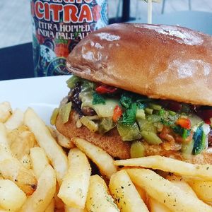 Our burger of the month for February, The Charlene. A Beyond Patty with bacon, Chao cheese, green chilies, pineapple pico, and teriyaki sauce on a brioche bun. 🔥 at Midtown Vegan Deli & Market in Tucson