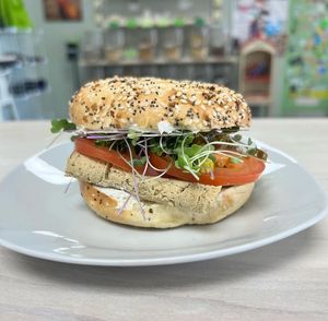 Super secret build your own bagel sandwich option! Pictured here is Tanya’s Turkey sandwich with cream cheese, Unreal Turkey, tomatoes, sprouts, and jalepenos, on a bagel 🥯. at Midtown Vegan Deli & Market in Tucson