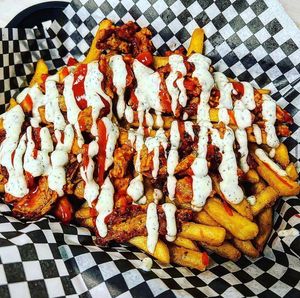 Highly addictive Loaded Buffalo Fries. Your choice of fries smothered in our house made ranch, Buffalo sauce, and marinated soy curls.  at Midtown Vegan Deli & Market in Tucson