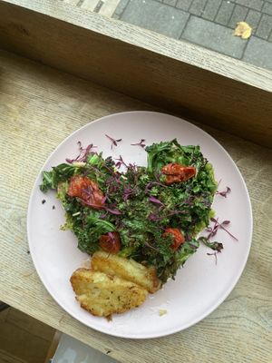 Smashed peas on toast with garlic aioli, crispy kale, roasted tomatoes and a side of hash browns  at Flour House in Bristol