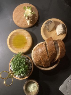 Homemade bread, local cashew cheese, basil oil, fresh bread, butter with onion and herb  at Glacier Fine Dining in Grindelwald