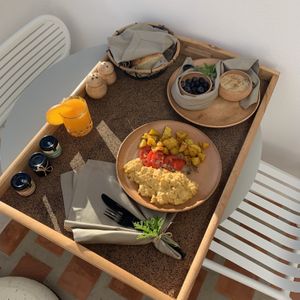 Breakfast day 2: tofu scramble with keshew cheeze and baked potatoes, rice pudding with fresh blueberries  at Ethos Vegan Suites in Santorini