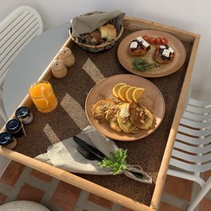 Breakfast day 3: Greek-style pancakes and crispy break with tomato tapenade, cheeze, capers and olives  at Ethos Vegan Suites in Santorini