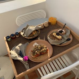 Breakfast day 5: oatmeal with walnuts, raisins, banana and blueberries, yoghurt with homemade grape jelly, toasted bread with tomato tapenade and roasted eggplant  at Ethos Vegan Suites in Santorini