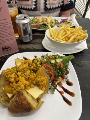 Coronation chickpea baked potato with vegan cheese   at NowNow Cafe in Livingston