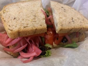 Veggie #1 roasted red peppers, artichokes, red onion, black olives, tomatoes, mixed greens and balsamic vinegar. (We asked to have the provolone removed and add pickled onions)  at Mountain Deli in Hendersonville