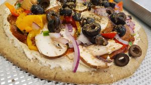 Mostly raw vegan pizza made with sprouted buckwheat crust, cashew cheese, and a sundried tomatoe sauce.  at Intuit Raw Foods in Lincoln