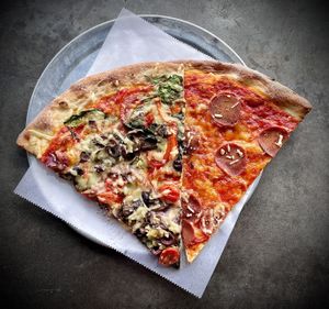 A veggie slice and a pepperoni slice  at Pizzanista in Los Angeles