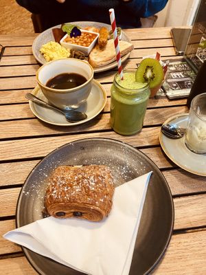 Pain au chocolat and green machine smoothie (full English in the background)  at Cafe@62 in Brighton