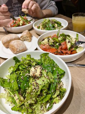 Amazing green salad with quinoa, pear and pomegranate seeds. And a bowl of tomato and cucumber salad. at Anoush in Yerevan