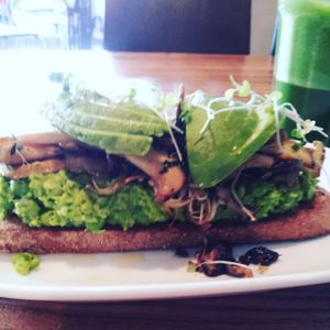 Smashed peas, mushrooms, avocado and truffle oil on toast at Source Foods in Perth