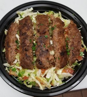Salad topped with beyond meat at Hummus Yummy in Valley Village