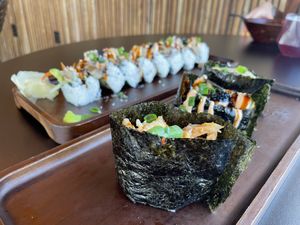 Sushi gunkan with lobster, lion’s mane, and scallops. Volcano roll in the back.   at House of Vegano in St Petersburg