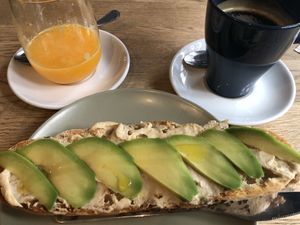 Toast with hummus, avocado, an americano and fresh orange juice.   at Kaputt in Cordoba
