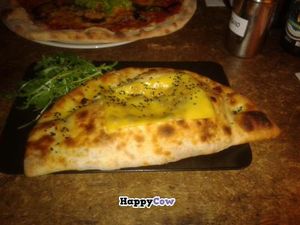 Calzone with cheese on top at Sfizy Veg in Berlin