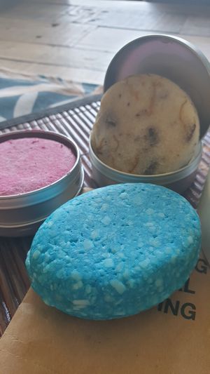 Pink: shampoo, blue: balsam, beige with orange stripes: shampoo at LUSH - Westfield Mall of Scandinavia in Solna