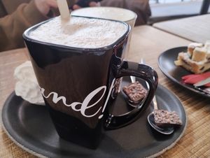 Oat milk latte & hot chocolate with vegan whip cream and vegan chocolates (instead of non-vegan cookie that usually comes with coffee) at Chocolate Company Cafe - Oude Binnenweg in Rotterdam