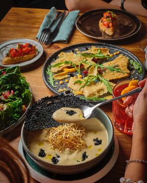 Leek Bisque, Crispy Leek Skins, Kombu Caviar, EVOO. at Earth House Restaurant And Wine Bar in Bangkok