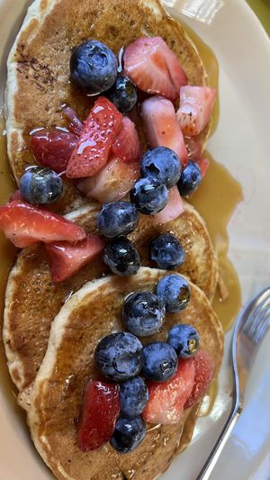 Banana Pancakes with Strawberries, Blueberries and Maple Syrup  at Snooze in San Diego