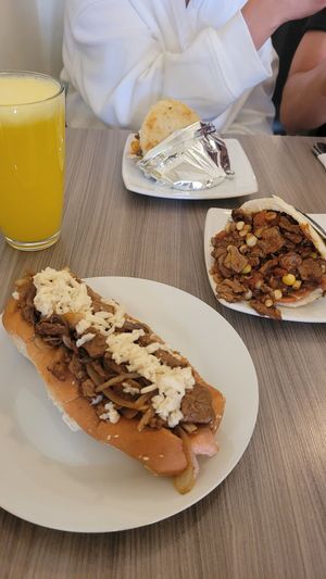 hot dog with seitan, arepa with corn and seitan and pineapple juice at Marvelous Vegan Plant Power Food in Bogota